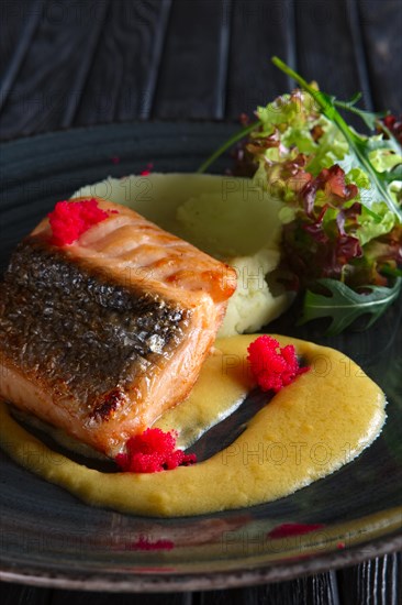 Fried salmon with mashed potato mixed with wasabi and decorated with flying fish roe