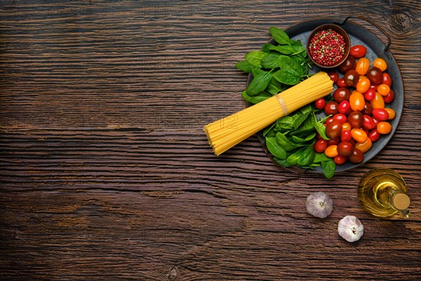 Overhead view of a bunch of raw spaghetti with spinach