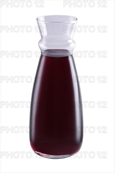 Pitcher with red wine isolated on white