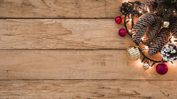 Cones with burning garland on table