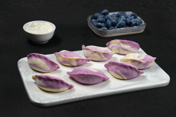 Frozen pierogi with blueberry and sour cream