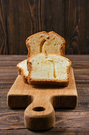 Closeup view of fresh biscuit cake with apple on wooden table