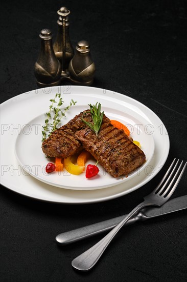 Two grilled beef steaks on a plate