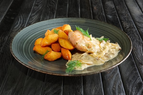 Potato balls with chicken fillet and mushroom and onion sauce