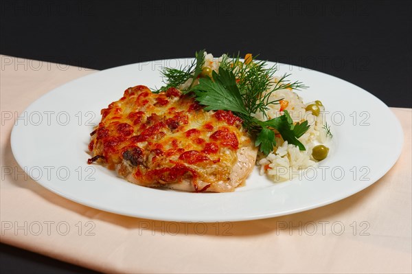 Plate with baked chopped chicken fillet with cheese and rice