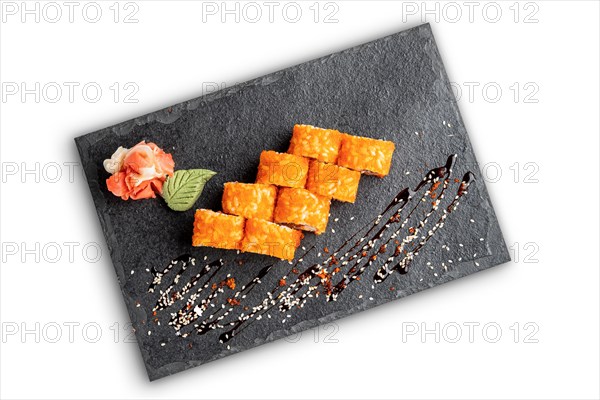 Set of rolls with wasabi and pickled ginger on stone serving board isolated on white