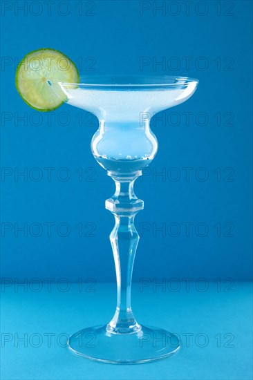 Gin tonic cocktail on blue background