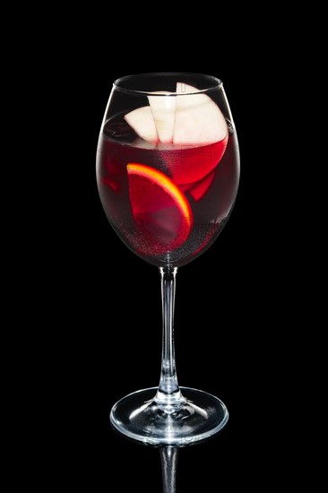 Cold sangria in wine glass with water spray