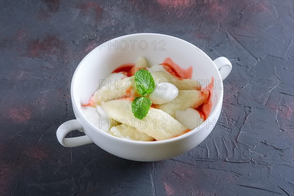 Lazy dumplings with sour cream and strawberry jam