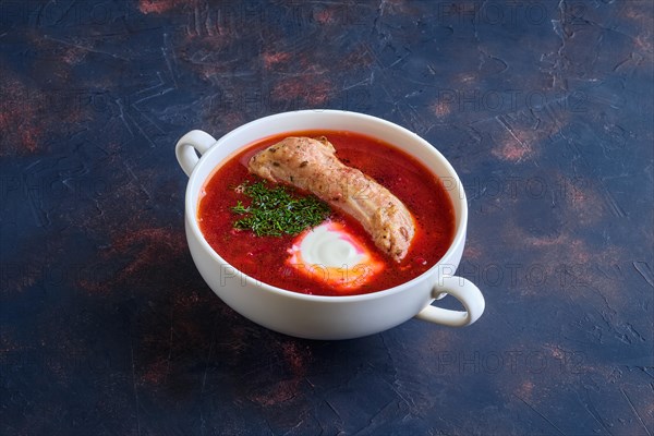 Beet and tomato soup with beef rib and sour cream