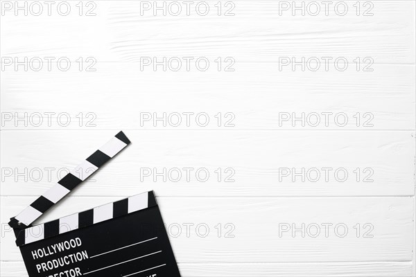 Opened clapperboard white table