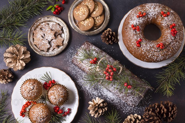 Top view of christmas desserts with red berries and pine cones. Resolution and high quality beautiful photo