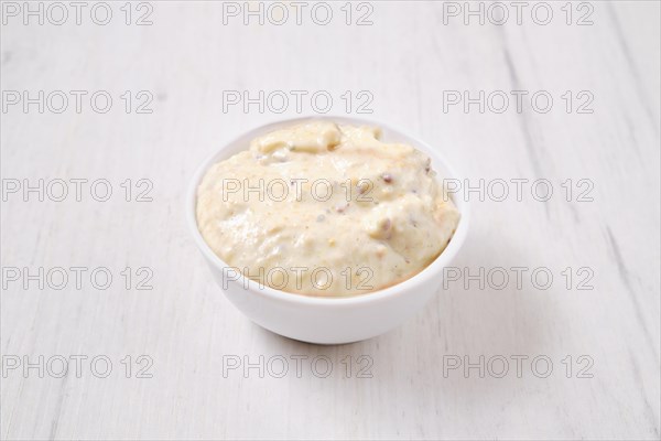 Small bowl with caesar sauce for salad