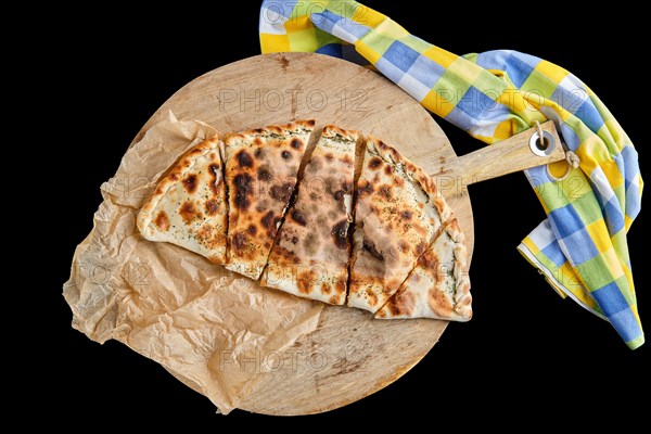Top view of pizza calzone on wooden board