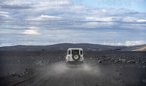 White Land Rover on a dirt road
