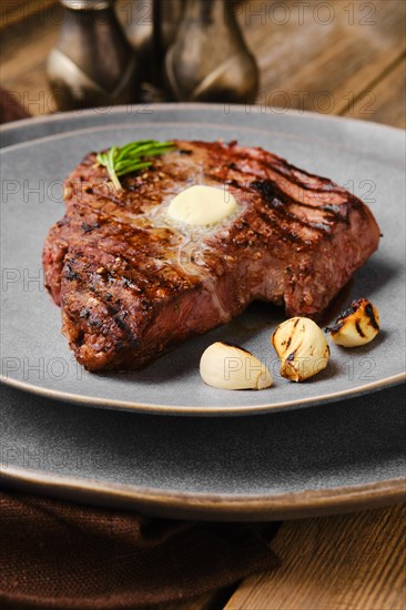 Closeup view of beef steak with a piece of butter on the top