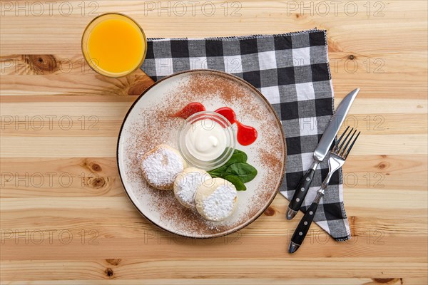 Traditional breakfast with cottage cheese pancake with sour cream