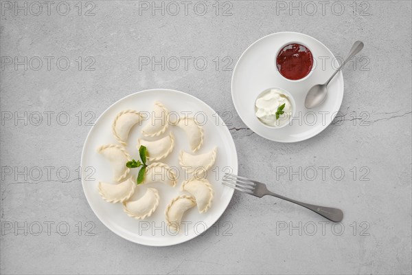 Frozen semifinished vareniki stuffed with cherry on grey background