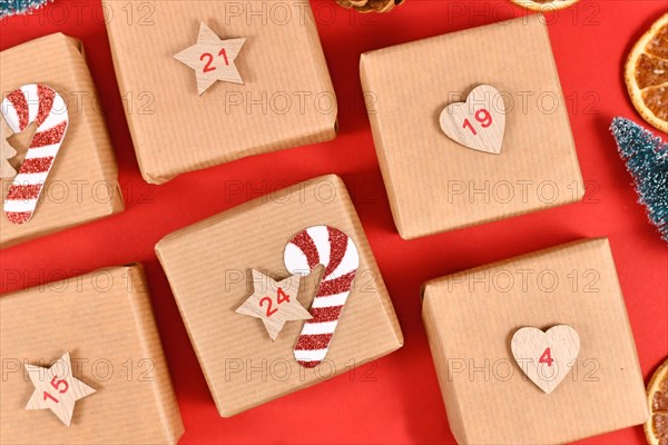 Homemade Advent calendar made from craft paper boxes on red background