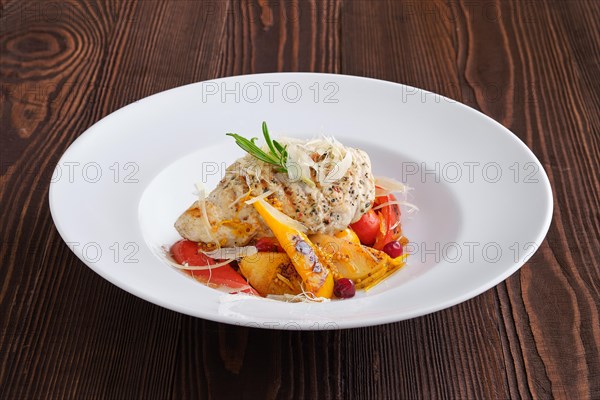 Fried turkey meat with roasted tomato and bell pepper served with parmesan