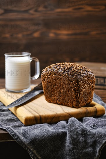 Fresh rye brown bread on wooden cutting board