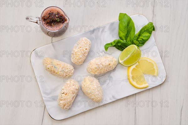 Top view of brown salmon meat cutlet in cheese breading