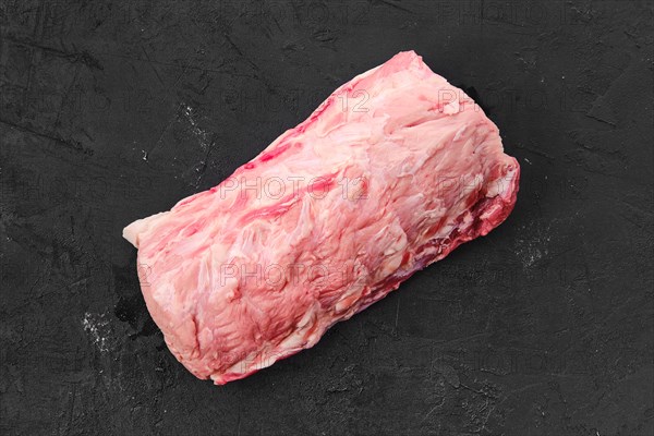 Raw fresh pork collar joint meat on black background