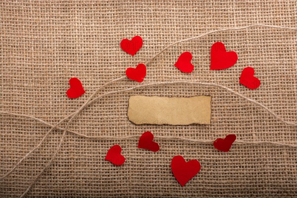 Love concept with heart shaped papers on linen threads