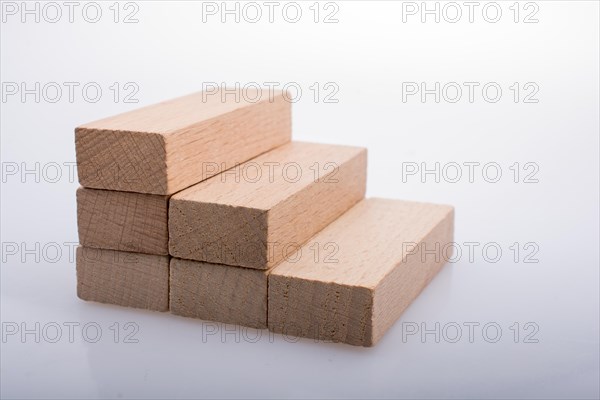 Wooden Domino Blocks in a line on a white background