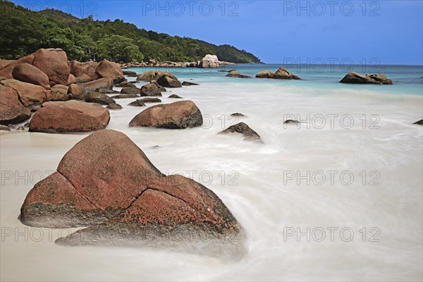 Granite rocks and beach of Anse Lazio in the evening