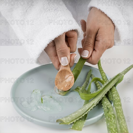 Close up hands taking aloe vera gel