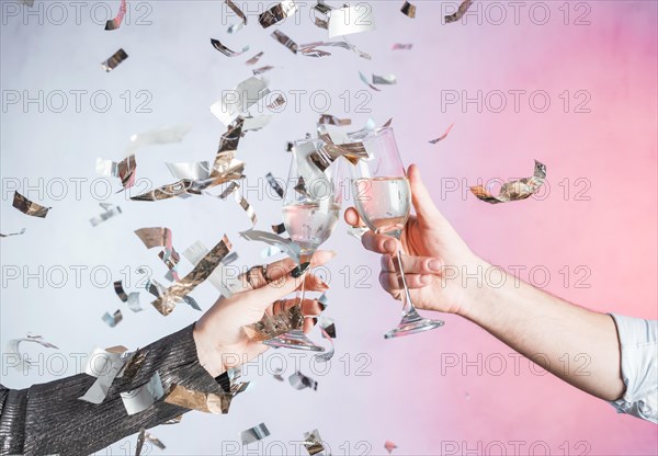 Hand toasting with confetti
