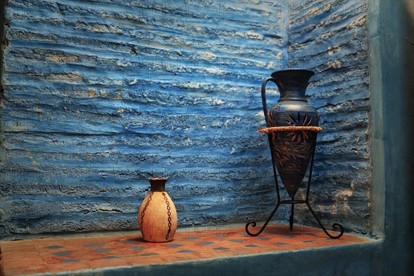 Two decorative jugs in a wall niche