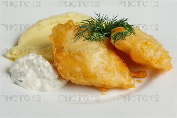 Close up view of fish fillet in batter with mashed potato