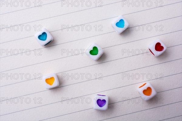 Colorful cubes with a heart placed on paper