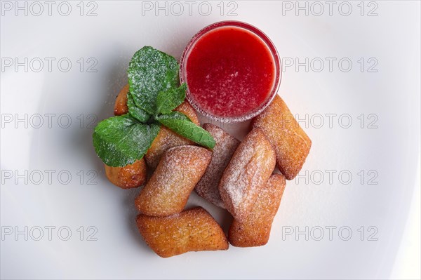 Top view of curd bars with strawberry jam decorated with mint leaf