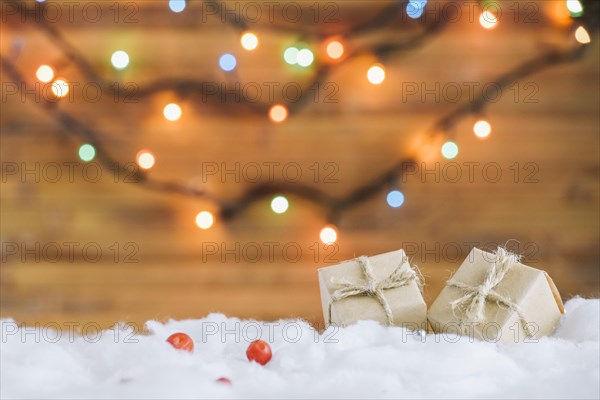 Present boxes decorative snow near fairy lights