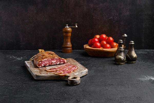 Homemade smoked pork sausage in organic casing on wooden cutting board