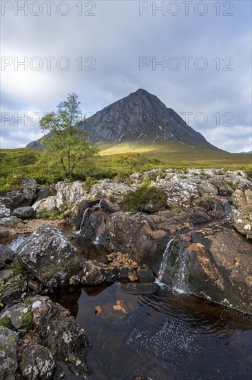 Waterfalls in front of mountain range Buachaille Etive Mor