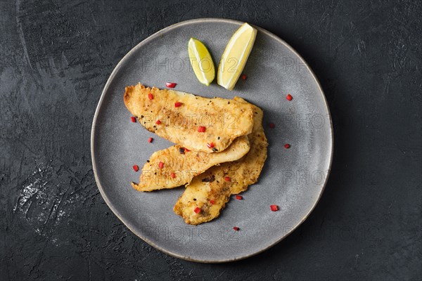 Top view of roasted hake fillet in breading