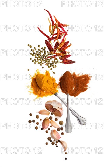 Composition with seasonings and herbs in bowls and spoons isolated on white background