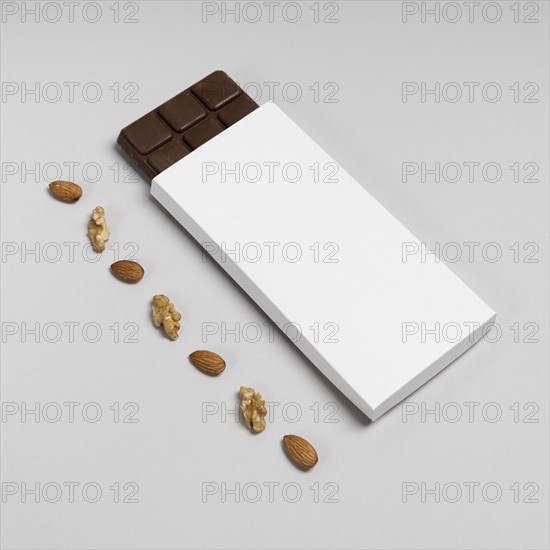 High angle blank chocolate bar package with nuts copy space