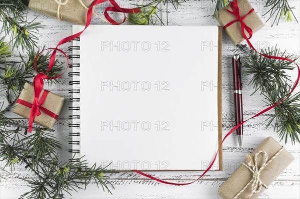 Notepad with fir tree branches table