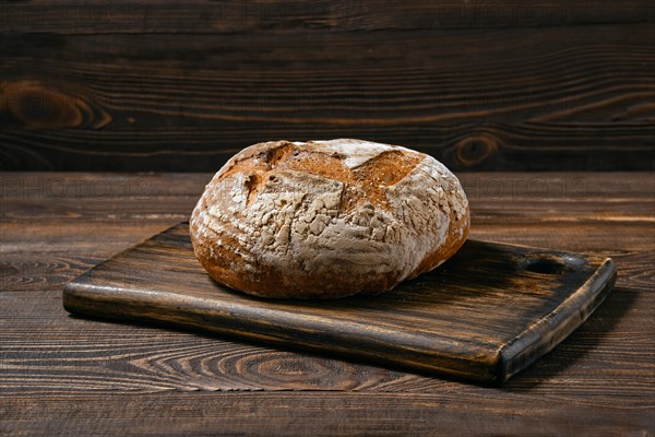 Artisan whole grain tomato wheat bread on wooden board