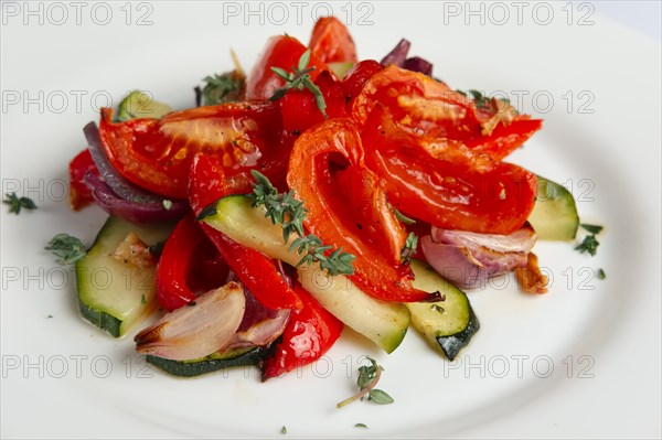 Grilled vegetables on white plate cutted on slices. Close up photo with selective focus