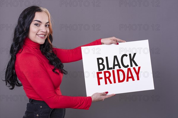 Beautiful woman holding a Black Friday sign. Commercial concept. Commerce