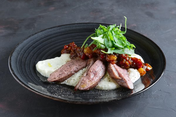 Roasted beef with caramelized vegetables and arugula