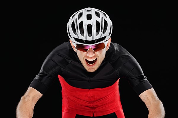 Sport. Cyclist in training clothes on black background