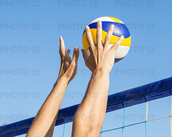 Man s hands preparing hit incoming volleyball net