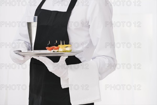 Servant uniform holding tray. Resolution and high quality beautiful photo
